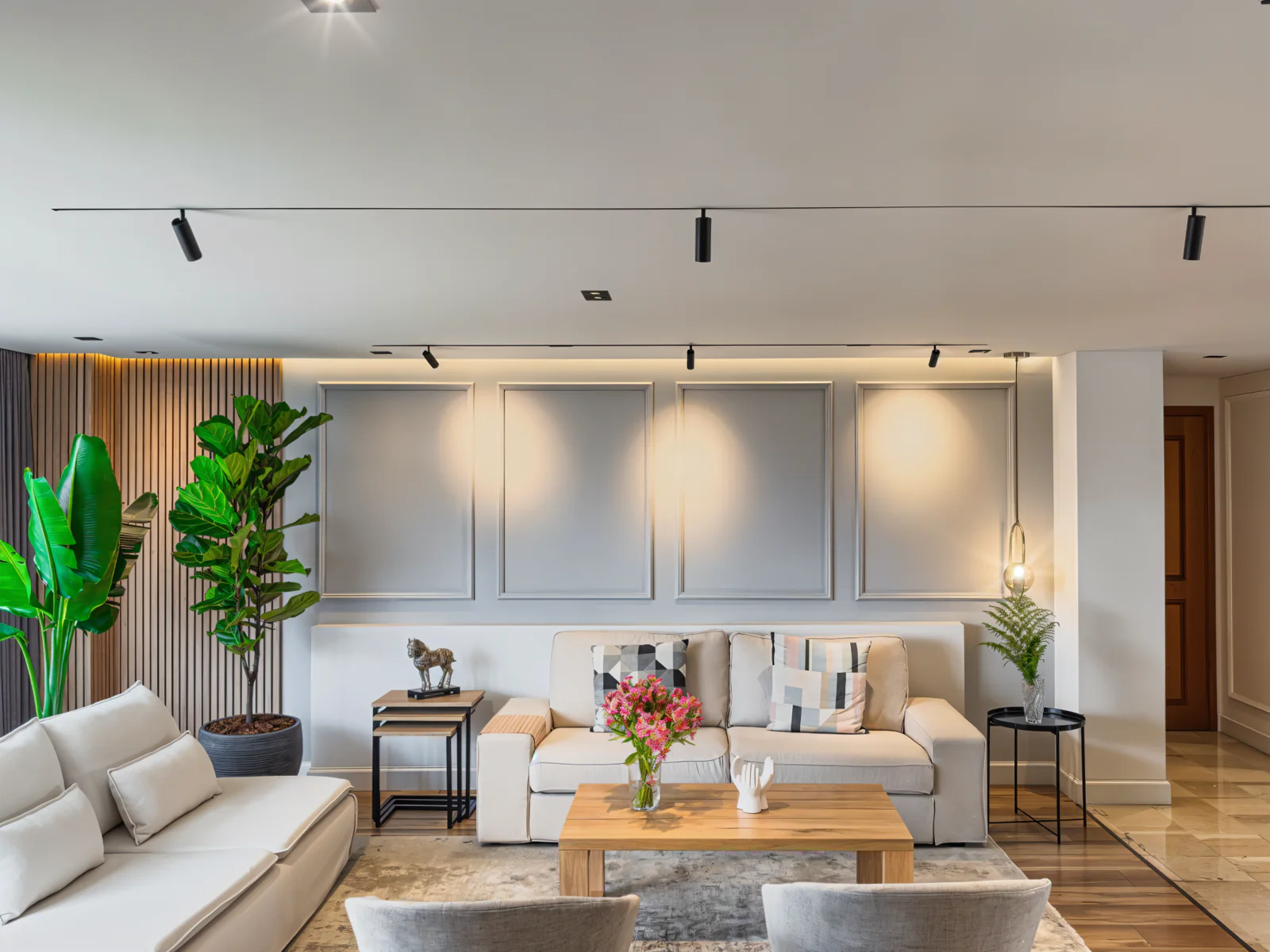 Rincón de Aguacatal – living room with gray paneled wall and track lighting