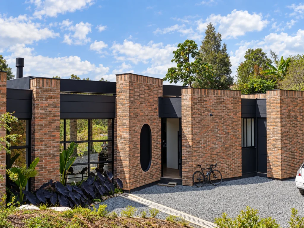 Casa Botero – main brick façade with gravel entrance