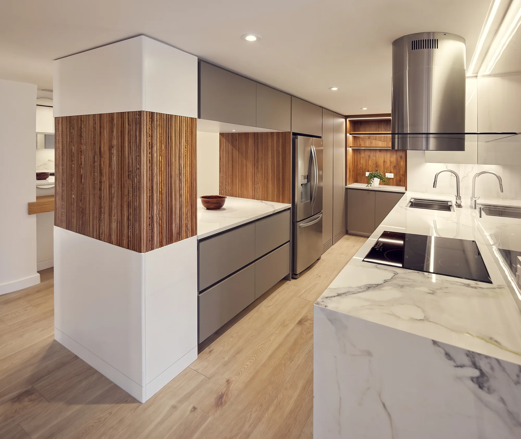 El Nogal Apartment – kitchen with marble island and wood paneling