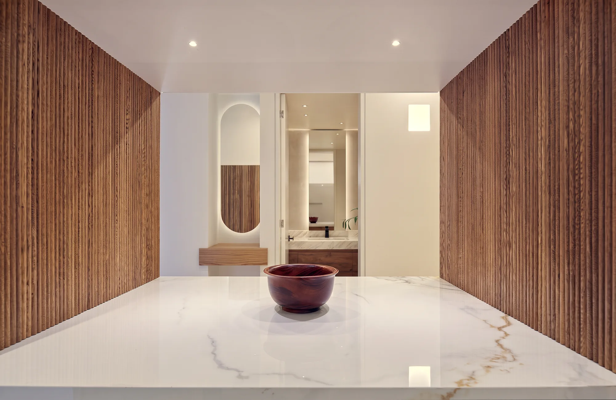 El Nogal Apartment – hall with wood paneling and marble floor